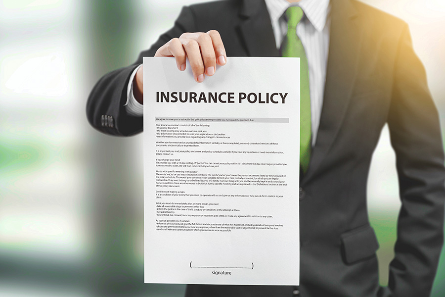 Business men holding a insurance policy document
